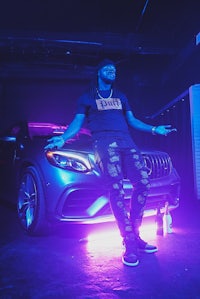 a man standing next to a mercedes benz
